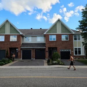 Roofers finishing up multi-family townhome condominium residence row – roofing job in Ottawa. Roofers finishing up multi-family townhome condominium residence row - roofing job in Ottawa.