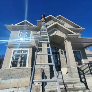 Done Right Roofing Installation Employee Climbing Up Ladder for New Home Done Right Roofing Installation Employee Climbing Up Ladder for New Home in Ottawa, work in progress beginning of Spring. Ottawa roof inspections done right.
